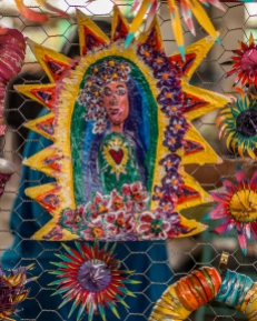 A colorful paper mache folk art piece depicting Saint Guadelopue, also known as the Virgin Mary
